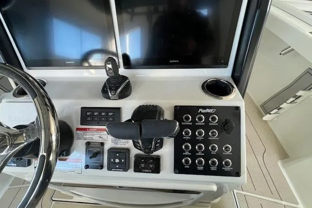 Slide: The Image of Control panel of 2025 Parker 2600 Center Console boat with dual screens and switches. - 17