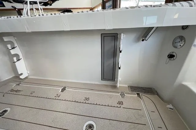 Slide: The Image of 2025 Parker 2600 Center Console boat interior with measurement markings and storage compartments. - 18