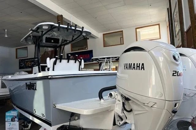 Slide: The Image of 2025 Parker 2600 Center Console boat with Yamaha 200 engine in showroom. - 2