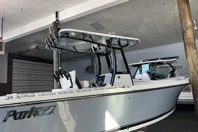 Slide: The Image of 2025 Parker 2600 Center Console boat in a showroom, featuring sleek design and modern equipment. - 21