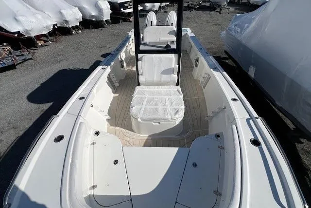 Slide: The Image of 2025 Parker 2600 Center Console boat with spacious deck and seating, docked outdoors. - 25