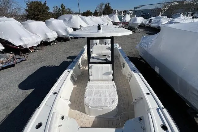 Slide: The Image of 2025 Parker 2600 Center Console boat in storage, surrounded by covered vessels. - 26
