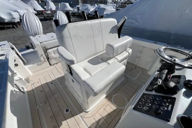 Slide: The Image of 2025 Parker 2600 Center Console boat interior with white seating and control panel. - 28