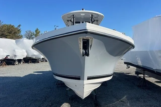 Slide: The Image of 2025 Parker 2600 Center Console boat, front view, parked outdoors on gravel. - 36