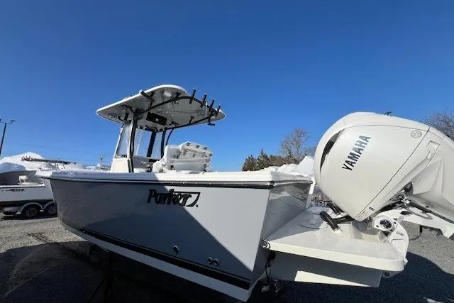 Slide: The Image of 2025 Parker 2600 Center Console boat with Yamaha engine, docked under clear blue sky. - 39