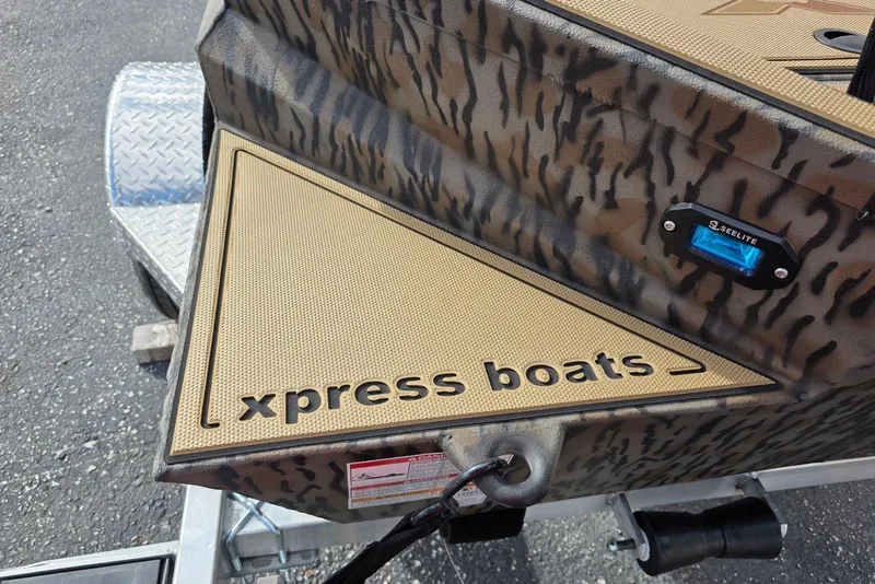 Slide: The Image of Xpress Bayou 180 boat, camo design, featuring "xpress boats" branding, 2026 model. - 10