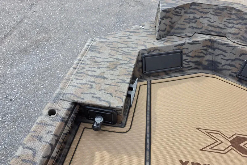 Slide: The Image of 2026 Xpress Bayou 180 boat with camouflage design and deck details. - 14