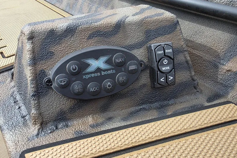Slide: The Image of Control panel of 2026 Xpress Bayou 180 boat with navigation buttons. - 18