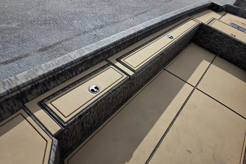 Slide: The Image of 2026 Xpress Bayou 180 boat interior with camo design and storage compartments. - 20