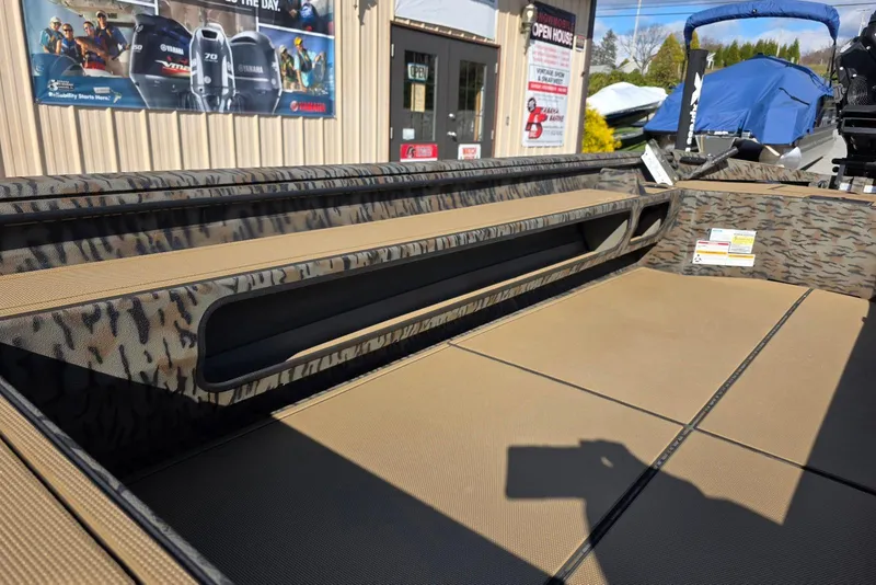Slide: The Image of 2026 Xpress Bayou 180 boat interior with camouflage design and storage compartments. - 24