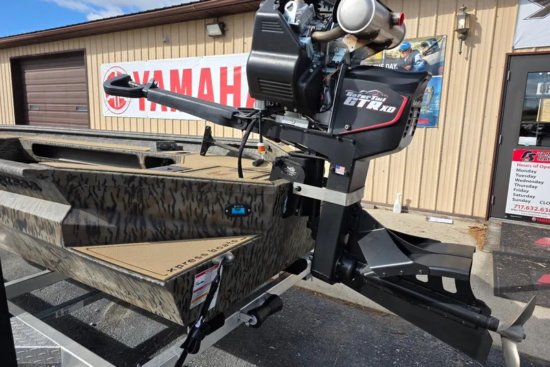 Slide: The Image of 2026 Xpress Bayou 180 boat with Gator Tail GTR XD motor, parked outside Yamaha dealership. - 8