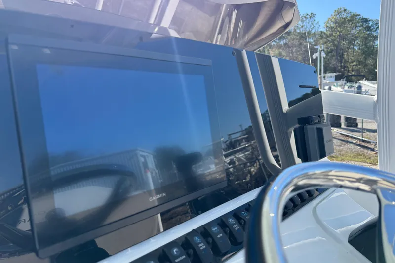 Slide: The Image of 2024 Sea Hunt Ultra 229 boat dashboard with Garmin display and steering wheel. - 9