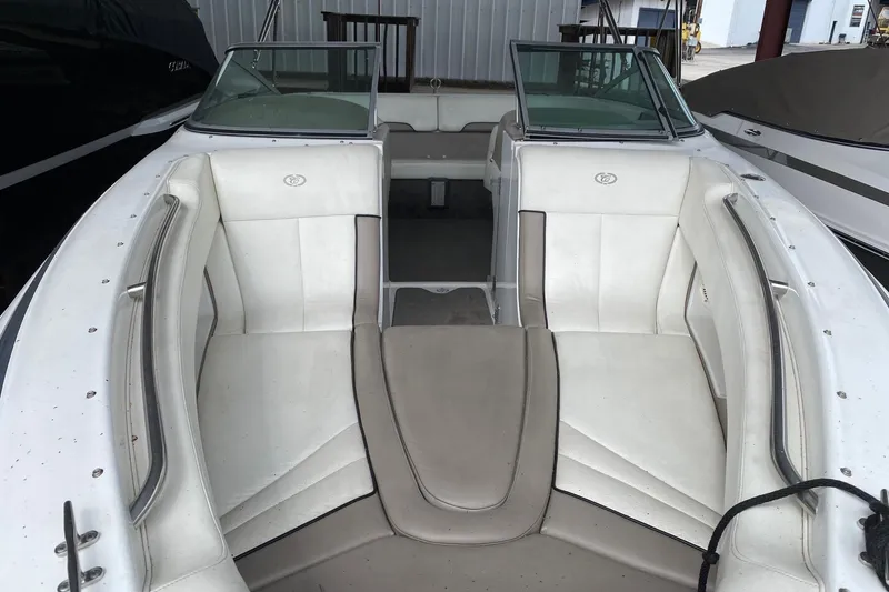 Slide: The Image of 1999 Cobalt 252 boat interior with white seating and windshield in a storage area. - 11