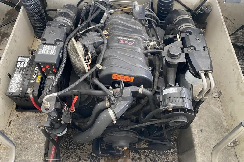 Slide: The Image of 1999 Cobalt 252 engine compartment with visible components and wiring. - 12