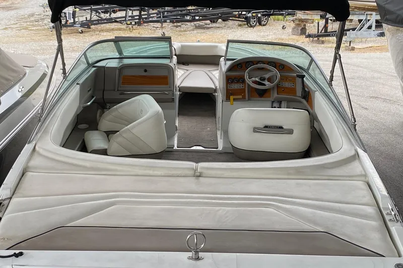 Slide: The Image of 1999 Cobalt 252 boat interior with white seating and dashboard view. - 4
