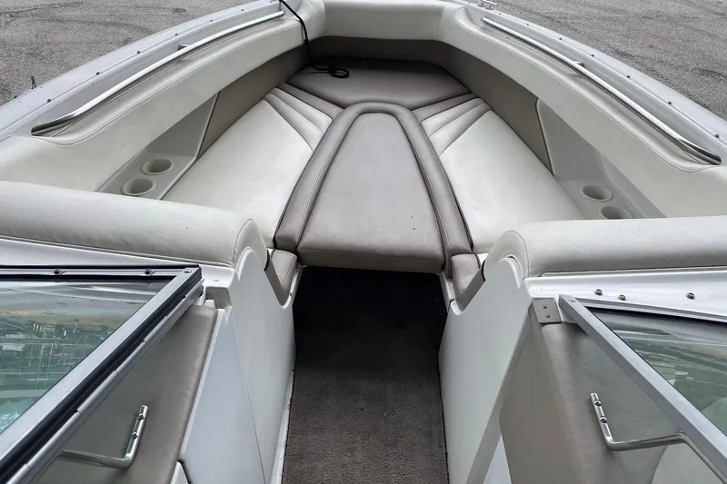 Slide: The Image of 1999 Cobalt 252 boat interior with white and gray seating, open bow design. - 9