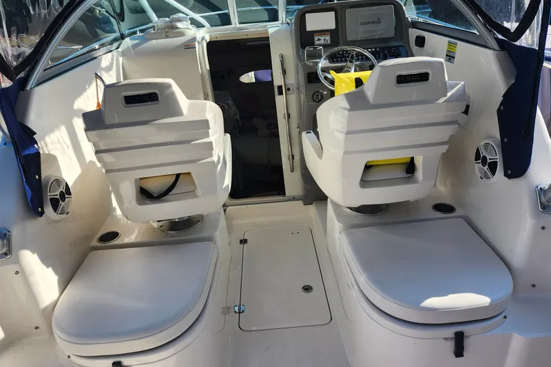 Slide: The Image of 2015 Robalo R245 Walkaround boat interior with helm, seats, and Garmin navigation system. - 10