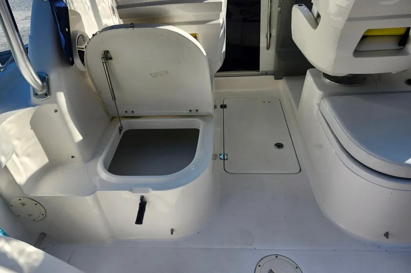 Slide: The Image of 2015 Robalo R245 Walkaround boat interior with open storage compartment. - 11