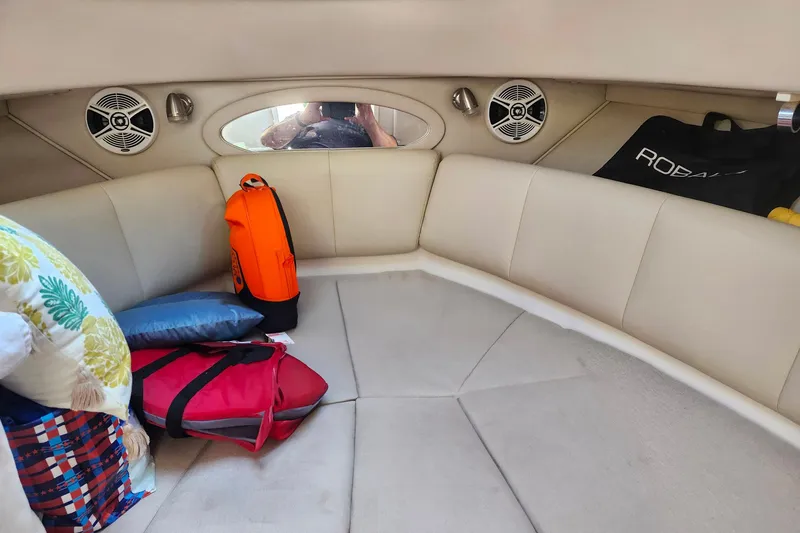 Slide: The Image of 2015 Robalo R245 Walkaround cabin interior with cushions and bags. - 6