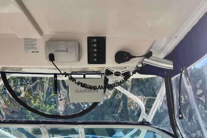 Slide: The Image of 2015 Robalo R245 Walkaround boat interior with Garmin electronics and communication equipment. - 8