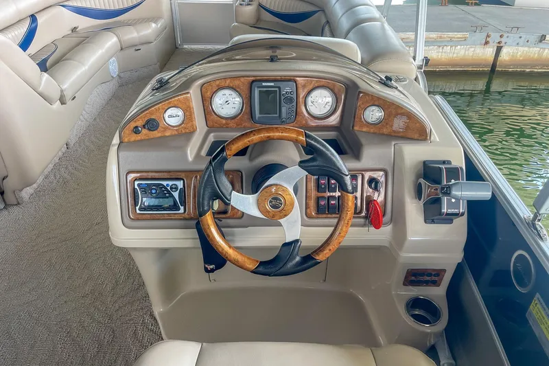 Slide: The Image of Steering console of a 2011 Berkshire 263 SLX pontoon boat with wood accents. - 14