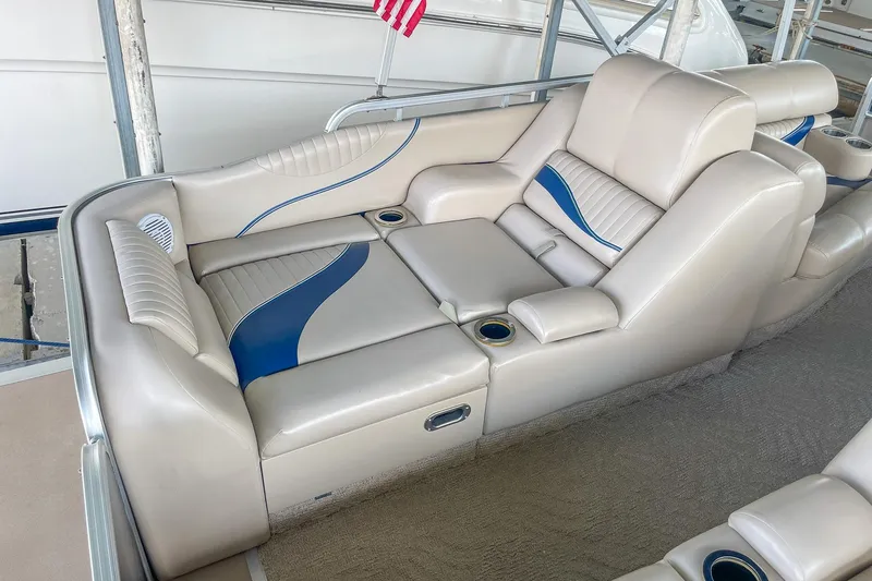 Slide: The Image of Luxurious seating on a 2011 Berkshire 263 SLX boat, featuring beige and blue upholstery. - 20