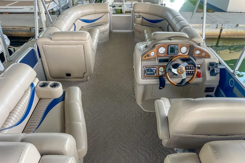 Slide: The Image of Luxurious interior of 2011 Berkshire 263 SLX pontoon boat with plush seating and modern dashboard. - 21