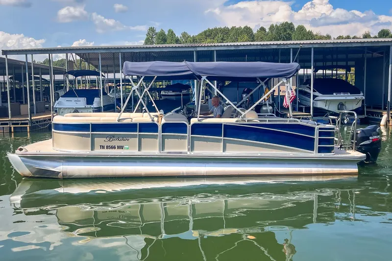Slide: The Image of 2011 Berkshire 263 SLX pontoon boat docked at marina with blue canopy. - 5