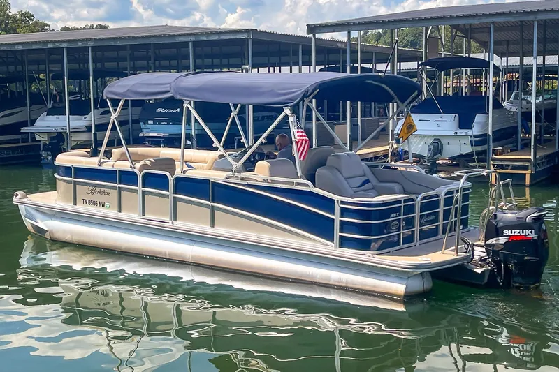 Slide: The Image of 2011 Berkshire 263 SLX pontoon boat docked with Suzuki outboard motor. - 6