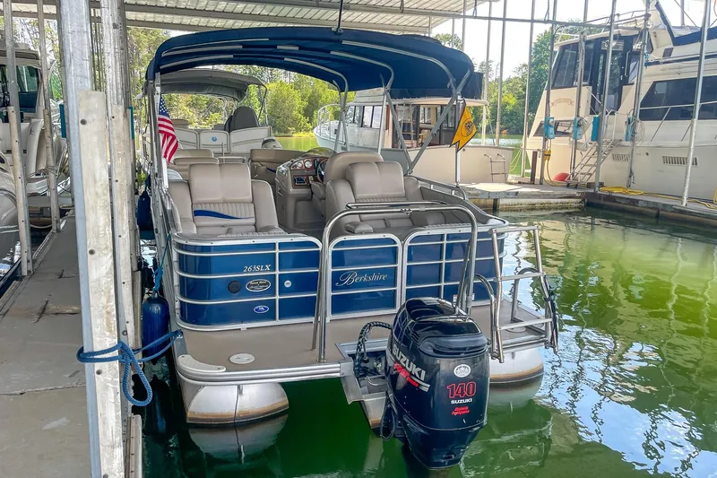 Slide: The Image of 2011 Berkshire 263 SLX pontoon boat docked with Suzuki 140 outboard motor. - 7