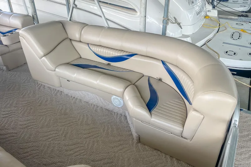 Slide: The Image of Luxurious beige seating on a 2011 Berkshire 263 SLX boat with blue accents. - 9