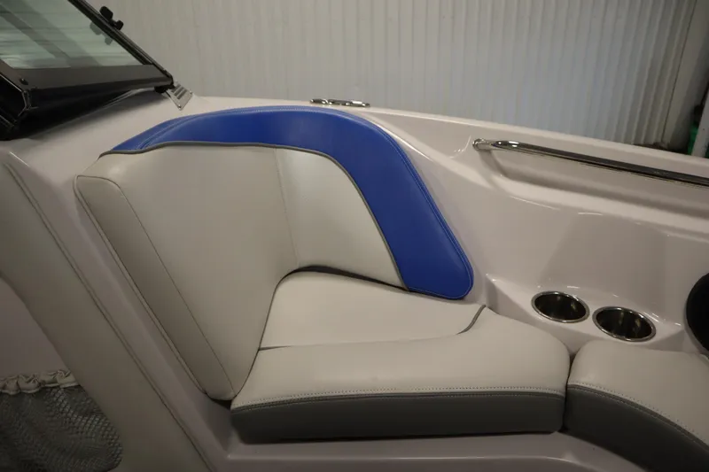 Slide: The Image of 2011 Nautique 210 SUPER AIR boat interior with blue and white seating, cup holders. - 13