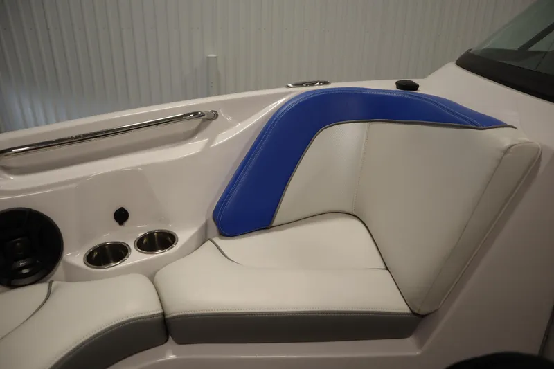 Slide: The Image of 2011 Nautique 210 SUPER AIR boat interior with blue and white seating, cup holders, and speaker. - 15