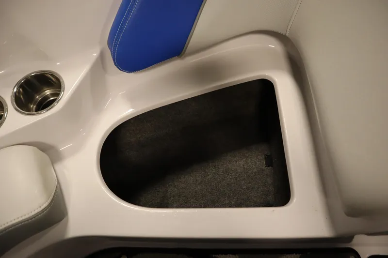 Slide: The Image of Interior storage compartment of 2011 Nautique 210 SUPER AIR boat with cup holders. - 16