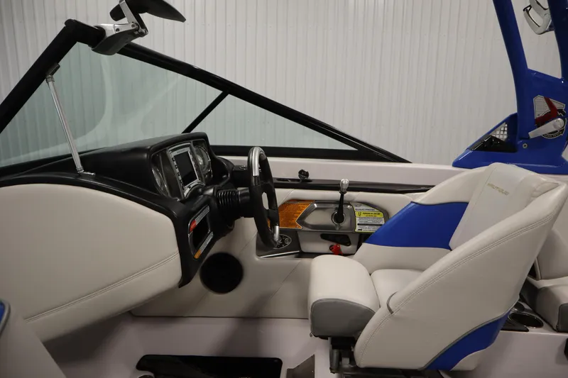 Slide: The Image of Interior of 2011 Nautique 210 SUPER AIR boat, featuring steering wheel and dashboard controls. - 17