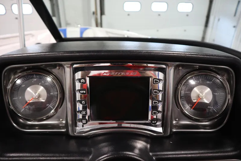 Slide: The Image of Dashboard of 2011 Nautique 210 SUPER AIR boat with gauges and central display. - 20