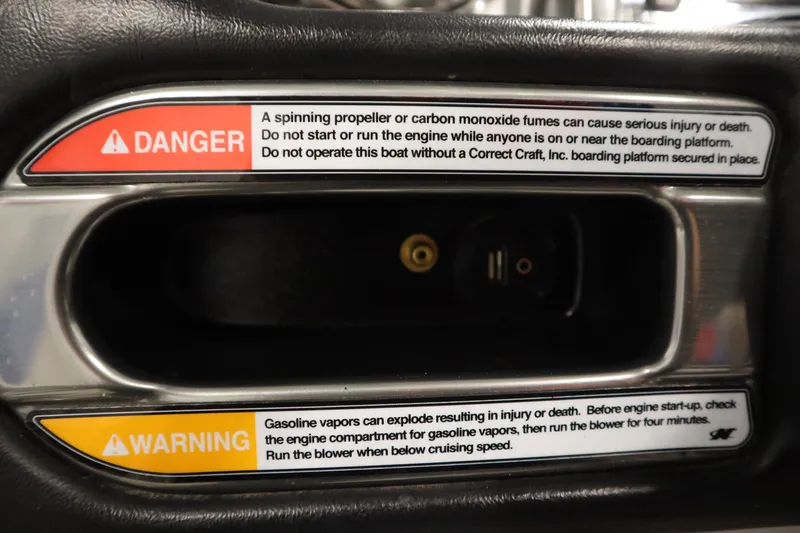 Slide: The Image of Warning labels on 2011 Nautique 210 SUPER AIR boat, highlighting safety precautions. - 22