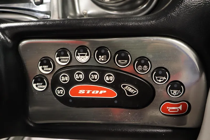 Slide: The Image of Control panel of a 2011 Nautique 210 SUPER AIR boat with various function buttons. - 23