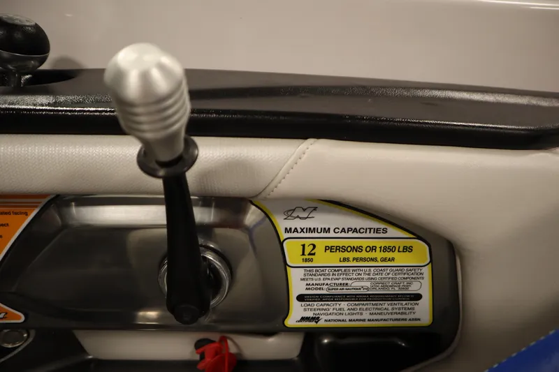 Slide: The Image of 2011 Nautique 210 SUPER AIR boat capacity label, showing 12-person or 1850 lbs limit. - 25