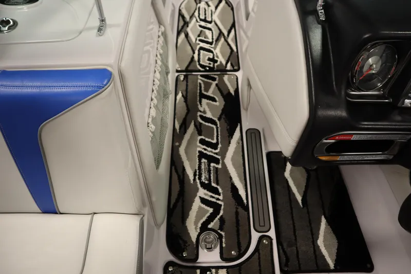 Slide: The Image of Interior of 2011 Nautique 210 SUPER AIR boat with custom flooring and seating. - 28