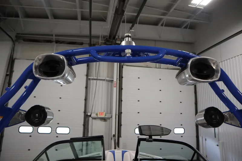 Slide: The Image of 2011 Nautique 210 SUPER AIR boat tower with speakers in a garage setting. - 45