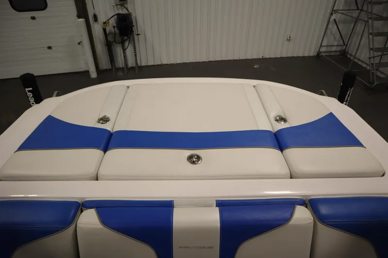 Slide: The Image of 2011 Nautique 210 SUPER AIR boat interior with blue and white upholstery. - 47