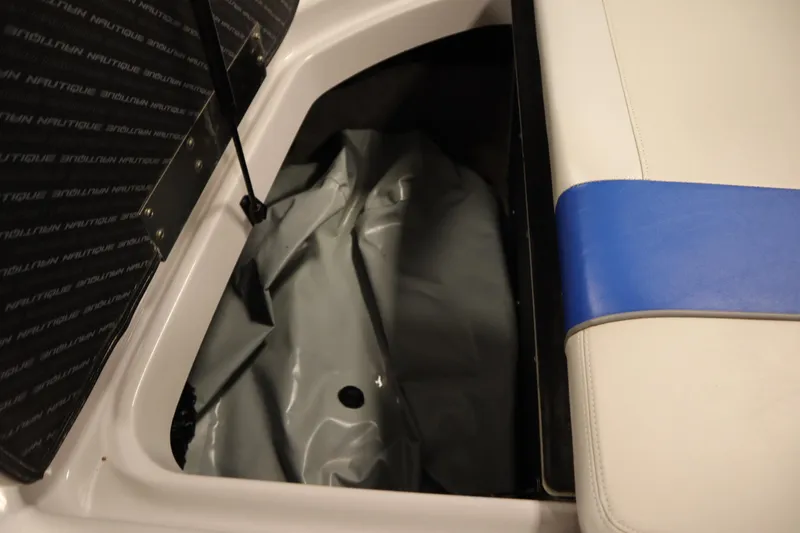 Slide: The Image of 2011 Nautique 210 SUPER AIR boat storage compartment with blue and white seating. - 50