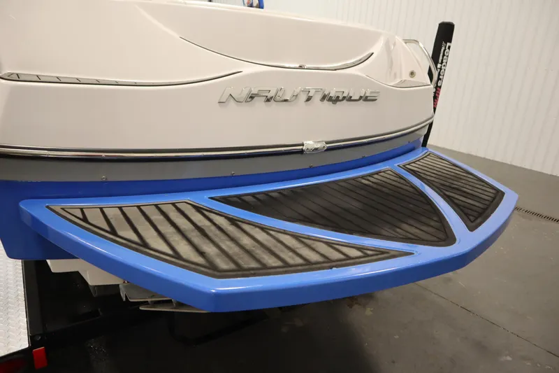 Slide: The Image of 2011 Nautique 210 SUPER AIR boat rear view with blue swim platform. - 51