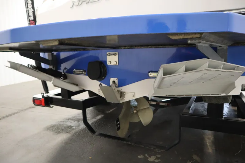 Slide: The Image of 2011 Nautique 210 SUPER AIR boat stern with propeller and trim tabs. - 52