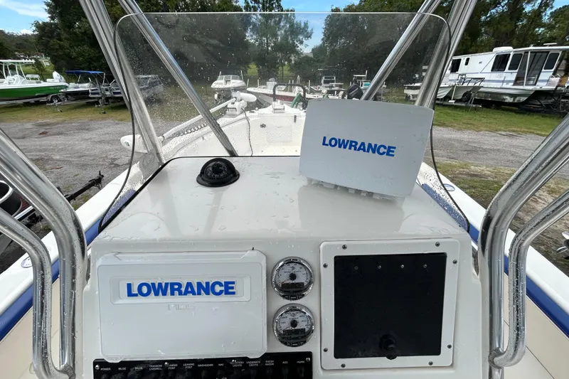 Slide: The Image of Triton 2486cc 2007 boat dashboard with Lowrance navigation system, parked outdoors. - 11