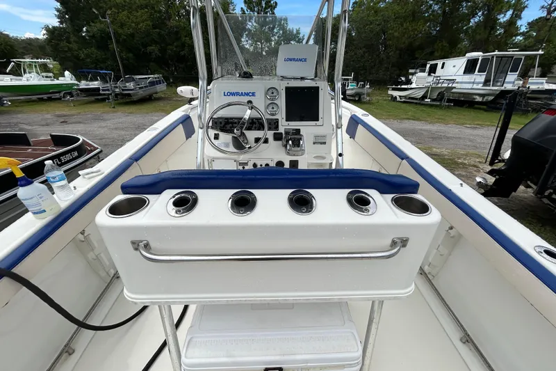 Slide: The Image of 2007 Triton 2486cc boat interior with steering console and rod holders. - 16