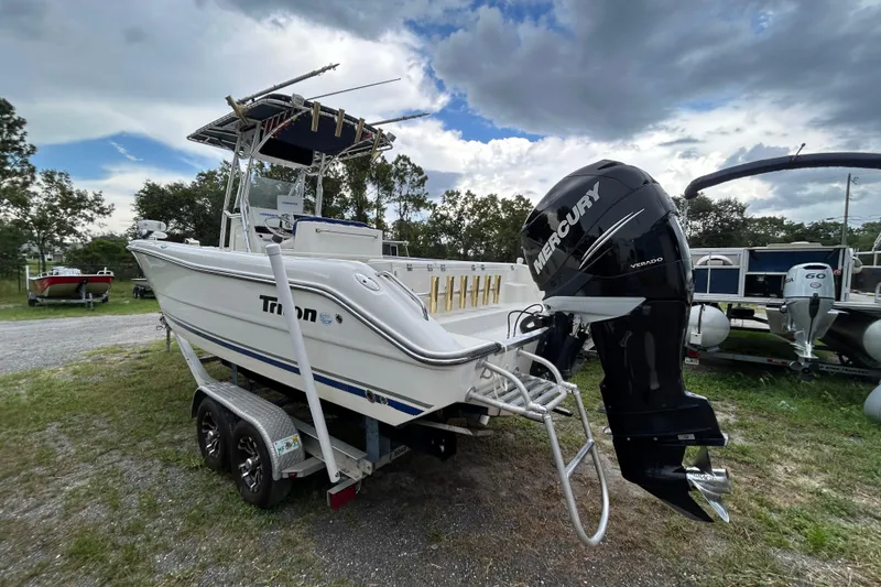 Slide: The Image of 2007 Triton 2486cc boat with Mercury Verado engine on trailer, parked outdoors. - 4
