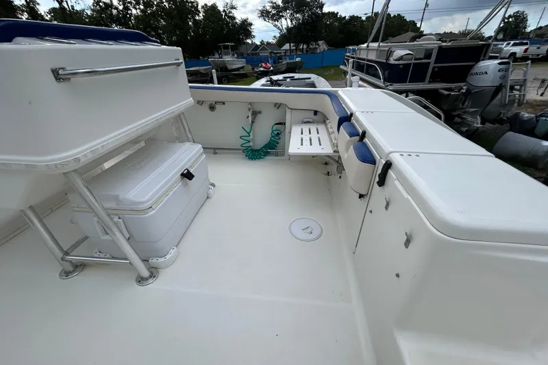 Slide: The Image of 2007 Triton 2486cc boat interior with storage and seating area. - 6