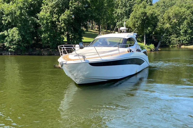 Slide: The Image of 2018 Galeon 385 HTS yacht with sleek deck design in marina setting. - 14